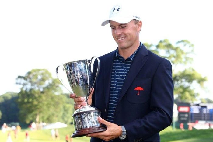 Jordan Spieth of the US poses with the winner's trophy after defeating Daniel Berger in a playoff in the final round of the Travelers Championship, at TPC River Highlands in Cromwell, Connecticut, on June 25, 2017