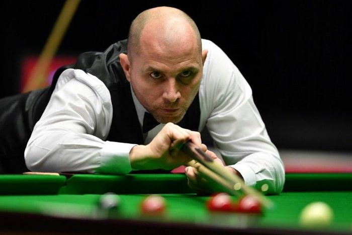 England's Joe Perry plays a shot during his quarter-final match against China's Ding Junhui during the Masters Snooker tournament at Alexandra Palace in London, on January 20, 2017