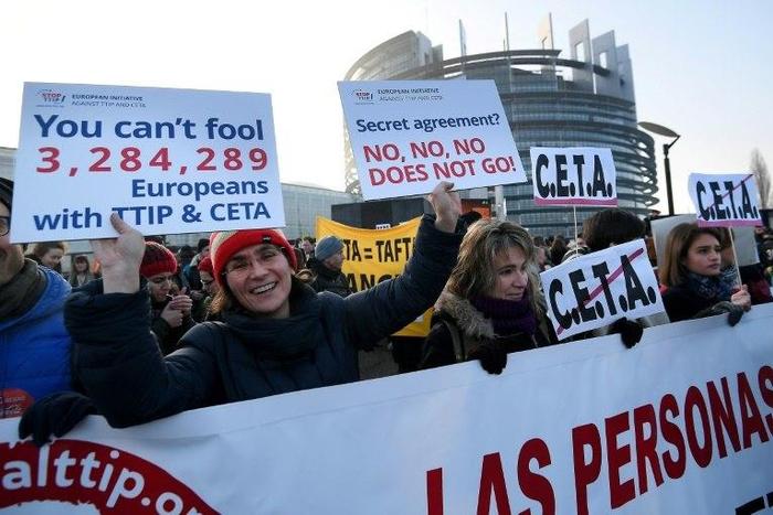Protestors demonstrate against the EU-Canada trade deal outside the European Parliament in Strasbourg, France