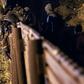 A Central American migrant scales the US-Mexico border fence from Tijuana, Mexico, into the US (L) on January 1, 2019