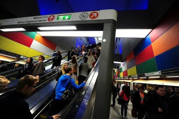 Passengers ride on an escalator in the Budapest metro system on March 28, 2014