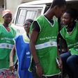Health workers try to board a vehicle taking them to designated centres to immunise children.