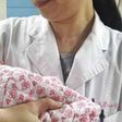 A doctor holds the healthy newborn boy at the First Affiliated Hospital of Sun Yat-sen University, in Guangdong.