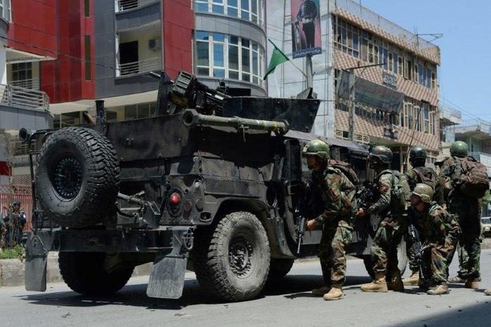 Afghan security forces take up a position at the site of suicide bombing in Jalalabad on May 17, 2017