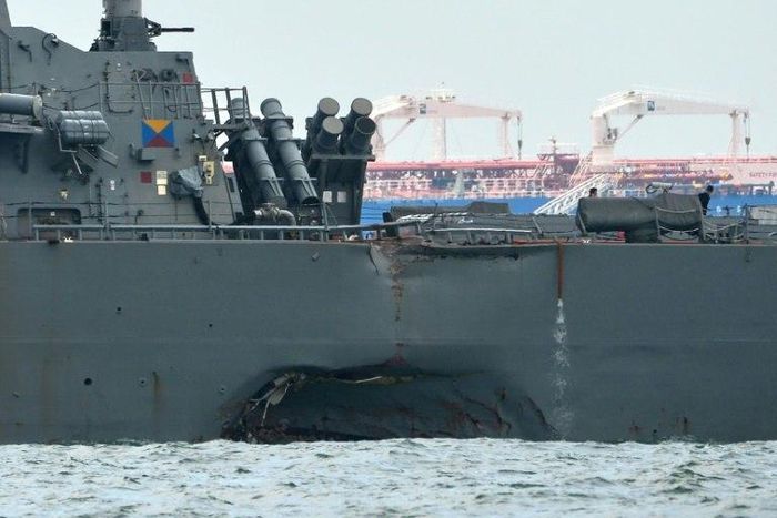 The USS John S. McCain with a hole on its port side