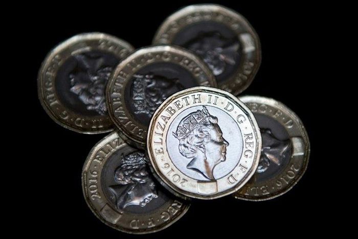 Newly issued 12-sided £1 (one pound) coins pictured in London on March 28, 2017, the day they entered UK circulation