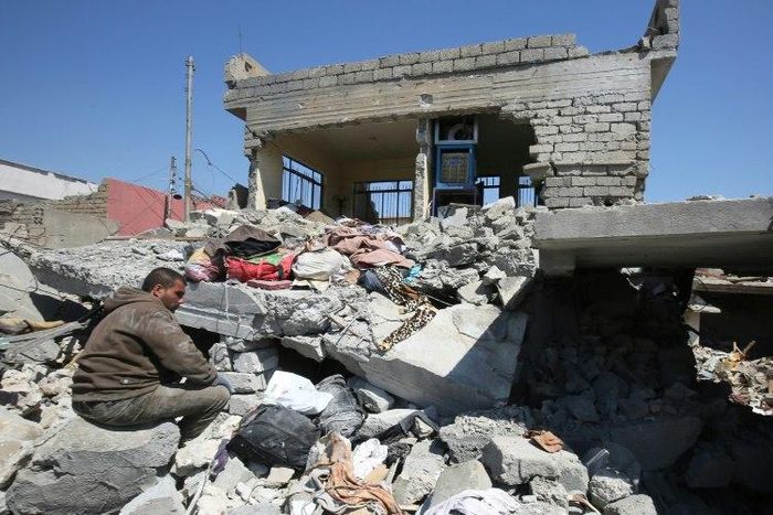 An Iraqi man in the rubble of destroyed houses in Mosul's al-Jadida area on March 26, 2017, after air strikes which reportedly killed civilians