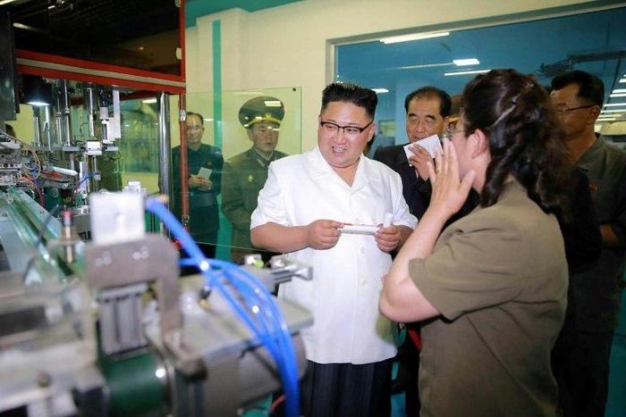 This undated picture released from North Korea's official Korean Central News Agency (KCNA) on June 20, 2017 shows North Korean leader Kim Jong-Un (C) visiting a newly-built dental sanitary goods factory at an undisclosed location in North Korea