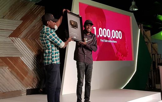 Comedian Mark Angel receiving the gold-plated YouTube plaque at Google For Nigeria for hitting 1 million YouTube subscribers, the first Nigerian-owned channel to do so.