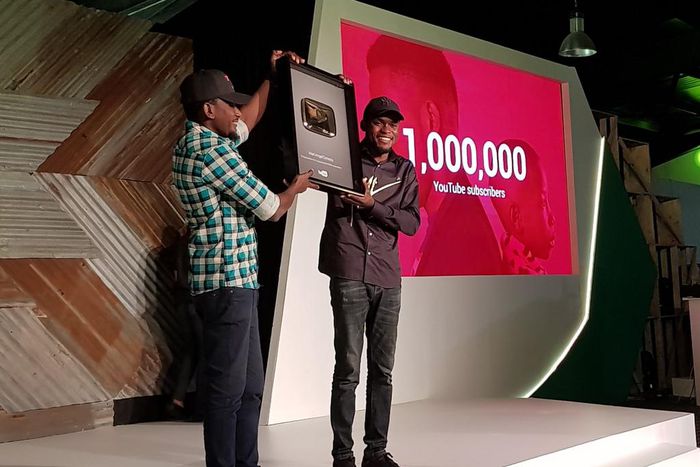 Comedian Mark Angel receiving the gold-plated YouTube plaque at Google For Nigeria for hitting 1 million YouTube subscribers, the first Nigerian-owned channel to do so.