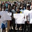 Protesters protesting the xenophobic attacks in India