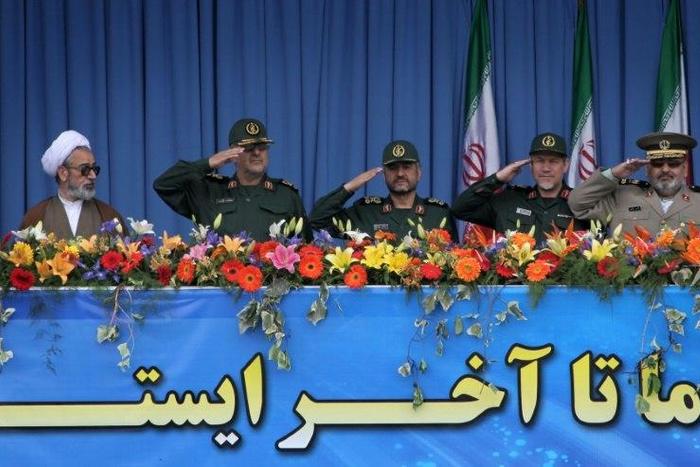 A clergyman looks towards top Iranian military commanders including (L) Mohammad Pakpour, head of ground forces of the Revolutionary Guards, during the Army Day parade in Tehran on April 18, 2010