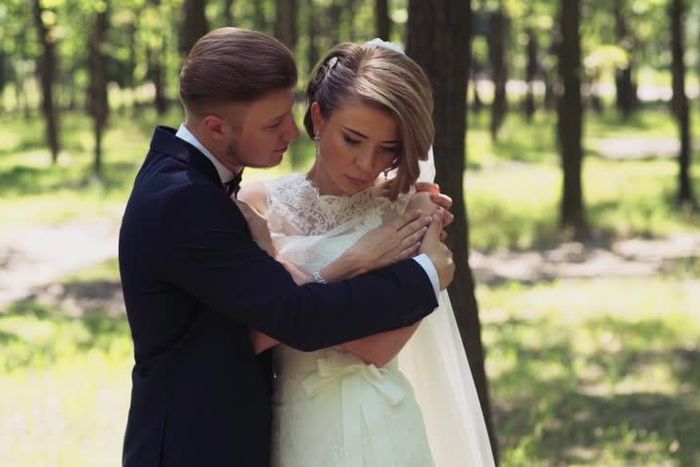 Groom embraces his sad bride