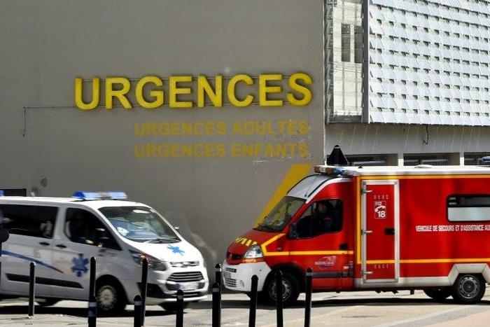 An ambulance and a firefighting vehicle are pictured in front of the Nantes CHU Hospital in this file photo from March 2017