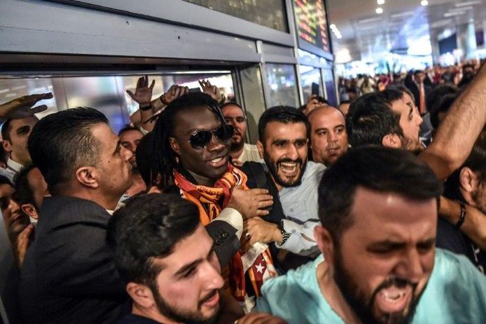French forward Bafetimbi Gomis (centre) is escorted outside the Ataturk International airport as he is greeted by fans upon his arrival, on June 28, 2017 in Istanbul