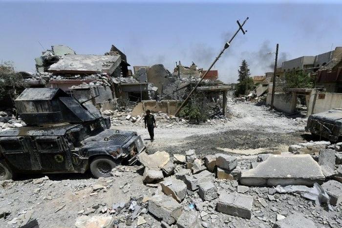 Iraqi security forces patrol west Mosul's al-Saha neighbourhood during their ongoing offensive to retake the city from Islamist fighters