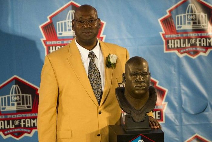 Former Seattle Seahawks defensive tackle Cortez Kennedy poses with his bust during the Class of 2012 Pro Football Hall of Fame enshrinement ceremony