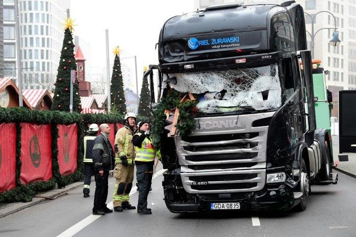 Investigators examine the truck that crashed the evening before into a Christmas market near Kaiser Wilhelm Memorial Church in Berlin, on December 20, 2016