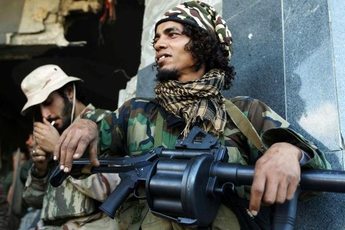 Fighters loyal to Libyan strongman Field Marshal Khalifa Haftar hold a position on the outskirts of second city Benghazi on January 14, 2017. He held talks on Tuesday with the country's internationally recognised prime minister Fayez al-Sarraj