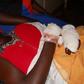 Olivia Nangozi on her hospital bed after her husband slit her neck
