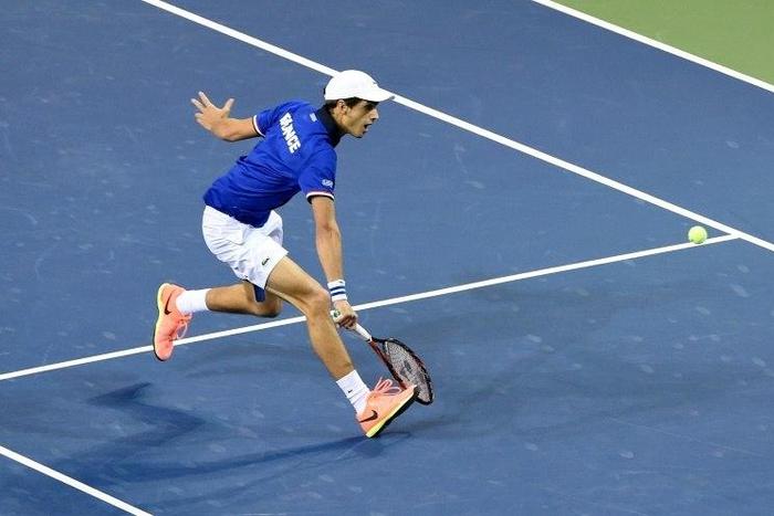 Pierre-Hugues Herbert of France returns a shot against Yasutaka Uchiyama of Japan during their Davis Cup World Group match, in Tokyo, on February 5, 2017
