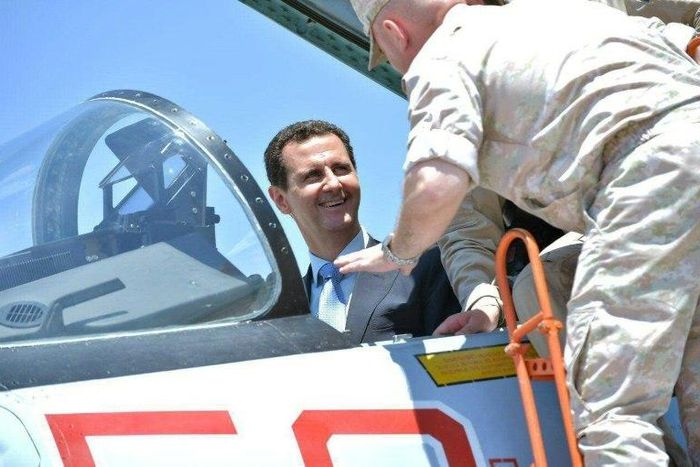 A handout picture released by the Syrian presidency on June 27, 2017 shows President Bashar al-Assad inside an Su-27 fighter jet during a visit to the Hmeimim military base in Latakia province