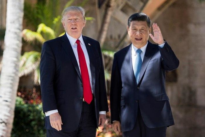 Chinese President Xi Jinping (right) waves to the press as he walks with US President Donald Trump at the Mar-a-Lago estate in West Palm Beach, Florida, April 7, 2017