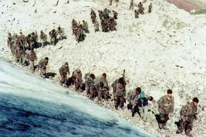 Bosnian army troops are seen walking up a hill near the city of Visoko, in 1995