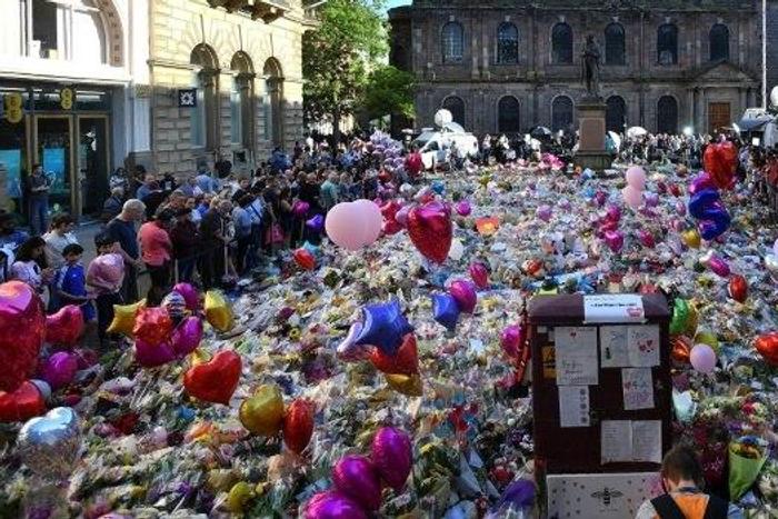 Flowers, toys and balloons cover St Ann's Square in central Manchester to honour the 22 people killed at the concert attack