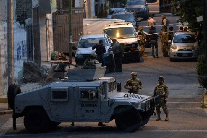 Mexican Marines stand guard after eight alleged criminals were shot dead in a rare shootout in the nation's capital