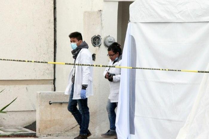 Forensic personnel work on a crime scene where attackers burst into a party and killed 11 people in Tizayuca, Mexico