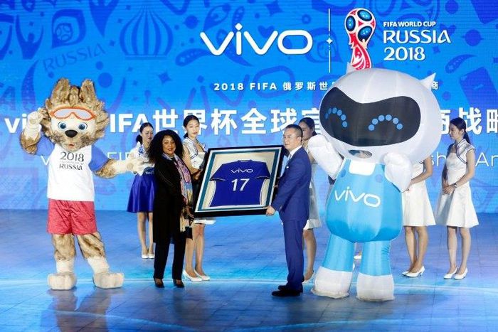 Vivo Senior Vice President Ni Xudong and FIFA Secretary General Fatma Samouraon hold a framed football jersey during an event on Beijing on May 31, 2017, to announce Vivo's sponsorship of the FIFA Football World Cup