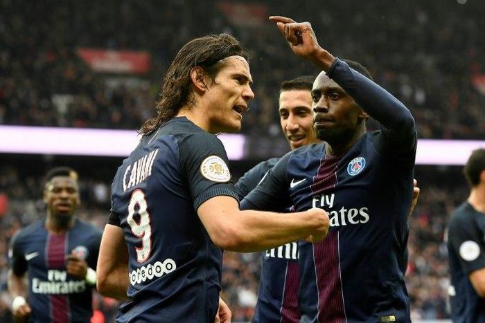 Paris Saint-Germain's Edinson Cavani (L) is congratulated by teammates after scoring a goal during their French L1 football match against Montpellier at the Parc des Princes stadium in Paris on April 22, 2017