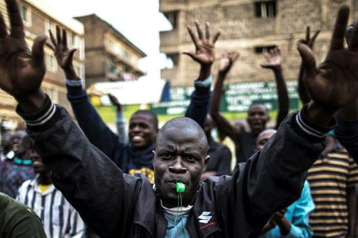 Opposition supporters march through Nairobi's Mathare slum, shouting 'Uhuru must go'