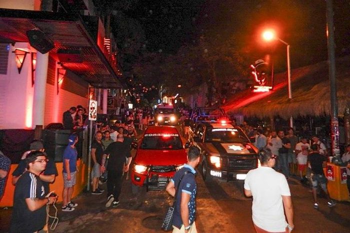 Firefighters and police stand outside the Blue Parrot nightclub in Playa del Carmen, Quintana Ro state, Mexico where 5 people were killed on January 16, 2017