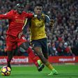 Liverpool's midfielder Sadio Mane (L) vies with Arsenal's striker Alex Iwobi during the English Premier League football match March 4, 2017