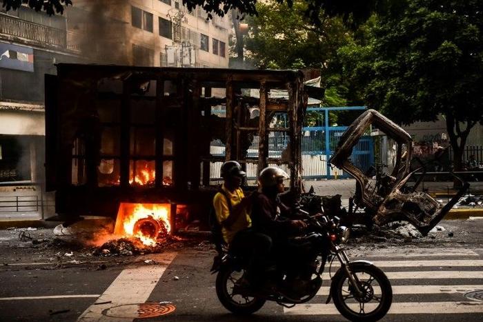 A truck burns during clashes between opposition activists and police in Caracas