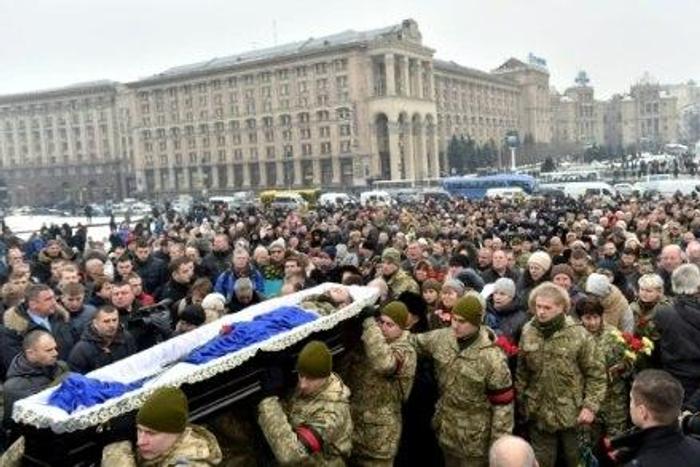 Mourners gather in Kiev's Independence (Maidan) Square on February 1, 2017, as servicemen carry the coffins of soldiers killed in eastern Ukraine
