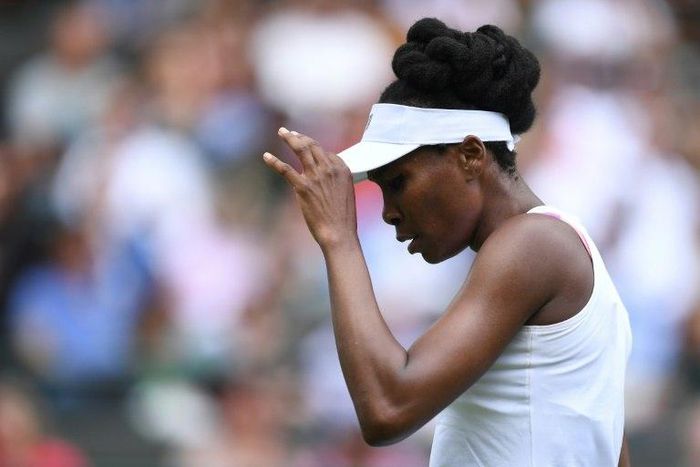 US player Venus Williams reacts between games against Belgium's Elise Mertens during their women's singles first round match on the first day of the 2017 Wimbledon Championships in London July 3, 2017