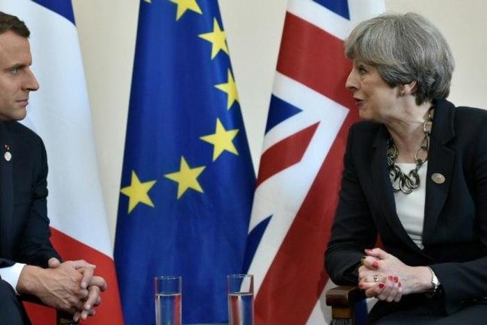 Britain's Prime Minister Theresa May and French President Emmanuel Macron talk on the sidelines of the G7 summit in Taormina, Italy, on May 26, 2017