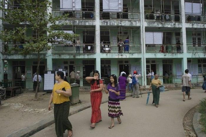 People leave a polling station after casting their votes in Myanmar by-elections, seen as a barometer for growing disillusionment in the country