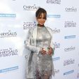 Halle Berry cradling what seems to be like a baby bump on the red carpet