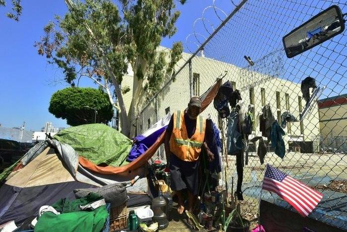 Homeless veteran Kendrick Bailey steps out of his tent on a streetcorner near Skid Row in downtown Los Angeles