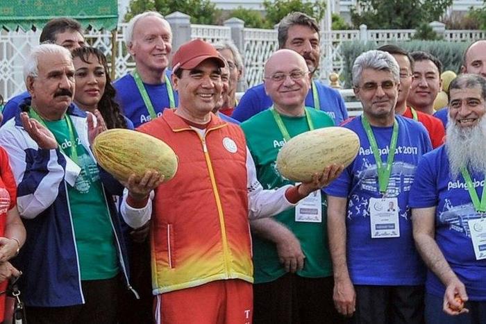 Turkmen President Gurbanguly Berdymukhamedov, surrounded by officials and participants of the upcoming 2017 Asian Indoor and Martial Arts Games, poses with melons during Melon Day celebrations in Ashgabat