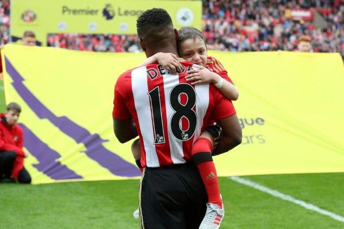 Then Sunderland striker Jermain Defoe holds Bradley Lowery at the Stadium of Light on May 13, 2017
