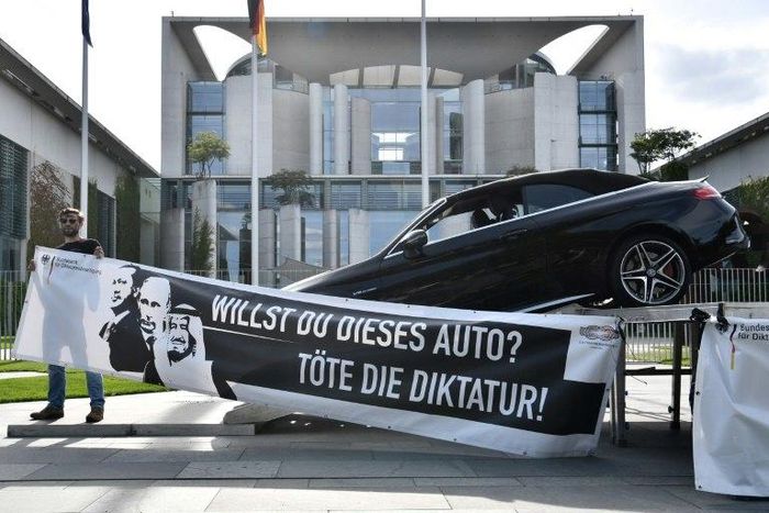 'Do you want this car? Kill dictatorship!' asks the slogan on the art installation outside Merkel's office, along with pictures of Erdogan, Putin, and King Salman