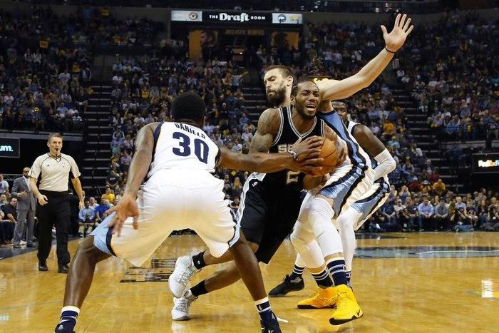 Kawhi Leonard of San Antonio drives between Troy Daniels (L) and Marc Gasol of Memphis Grizzlies during a 103-96 Spurs win in Game 6 of the Western Conference Quarterfinals