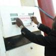 DPR official sealing a filling station
