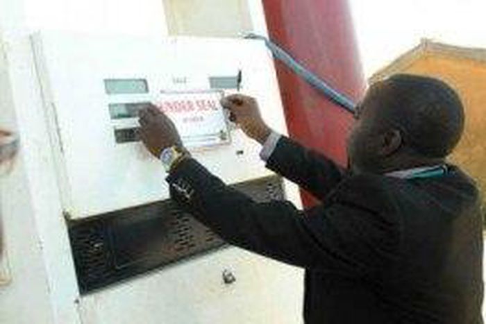 DPR official sealing a filling station