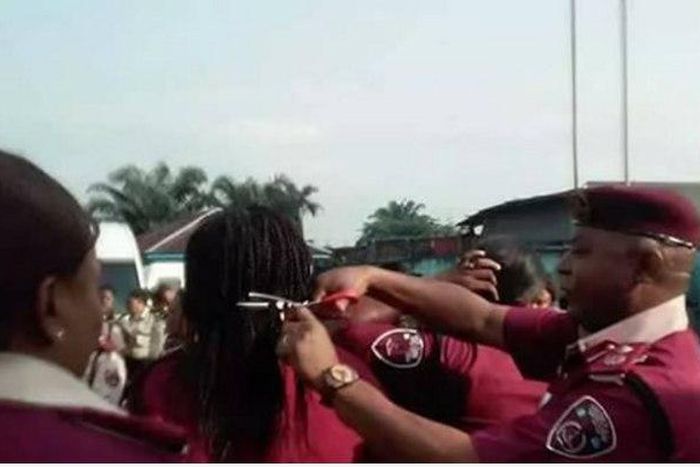 Rivers State Sector Commander, Andrew Kumapayi cutting the hair of some female officers.